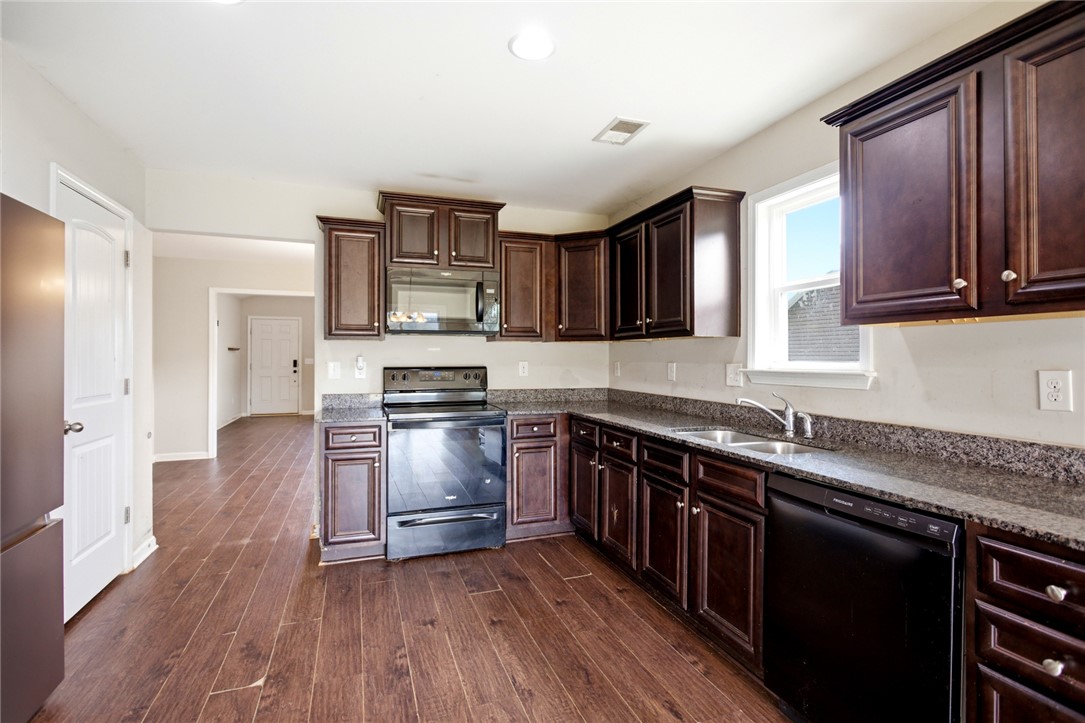 245 Maple Grove Road Seneca, SC 29678 - Photo 12 of 40 This functional kitchen features dark cabinetry, ample counter space, and durable flooring.