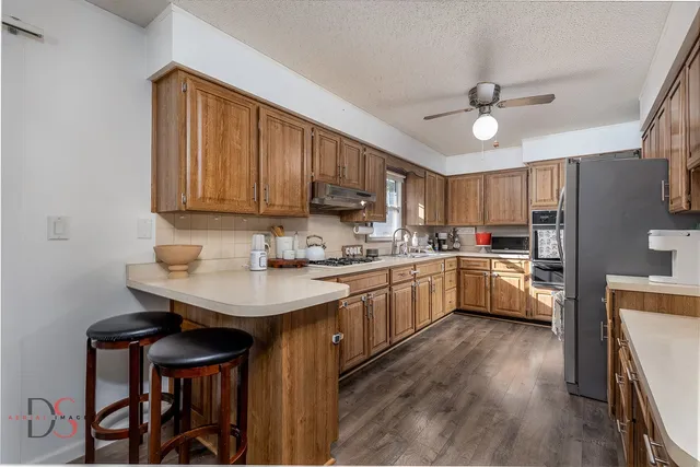 a kitchen with a sink cabinets and wooden floor
