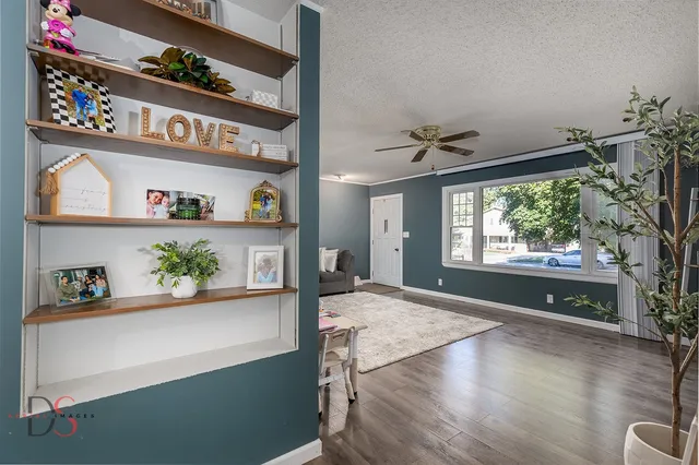 a living room with hard wood floors and a window