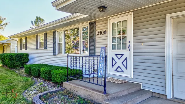 a view of front door and brick wall