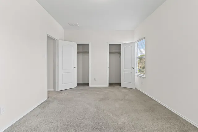 an empty room with closet area