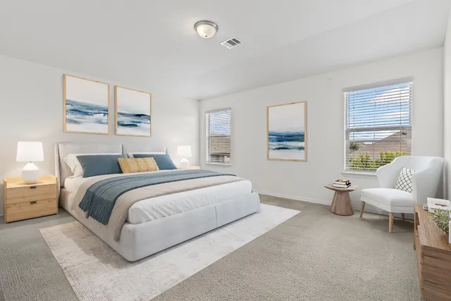 a spacious bedroom with a bed and a large window