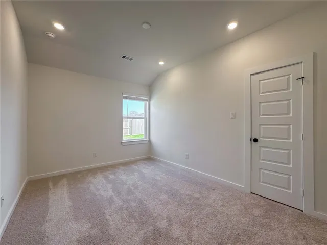 an empty room with windows and closet