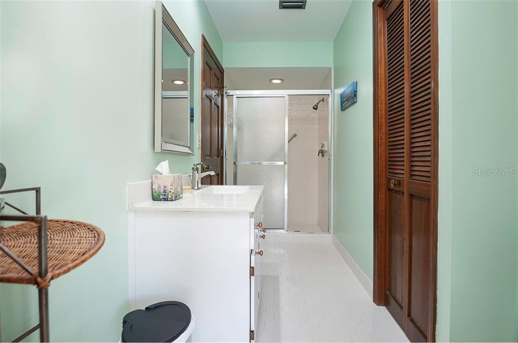 145 Spring Chase Circle Altamonte Springs, FL 32714 - Photo 31 of 54 The guest bath has a walk-in shower, newer cabinet and quartz counter top.