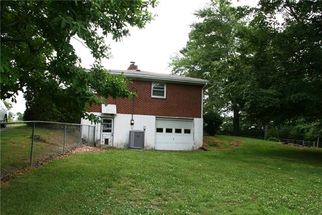 7151 Harper Road Joelton, TN 37080 - Photo 17 of 20 A view of the Side Entrance with the 1 Car Basement Garage and back yard Fence.