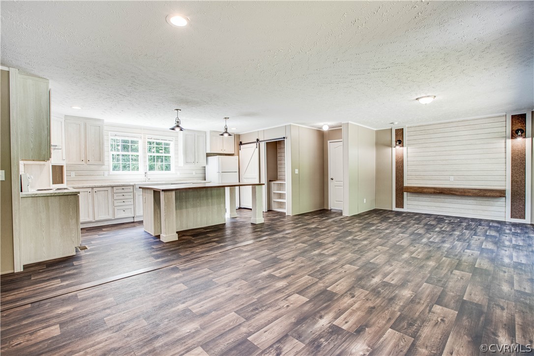 411 Goodwin Store Road Louisa, VA 23093 - Photo 15 of 38 a view of a kitchen with wooden floor and a refrigerator