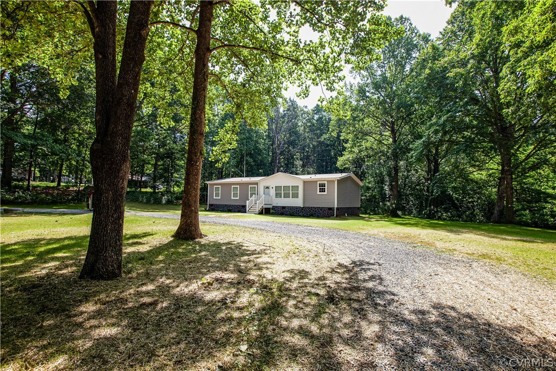 411 Goodwin Store Road Louisa, VA 23093 - Photo 28 of 38 a house with trees in the background
