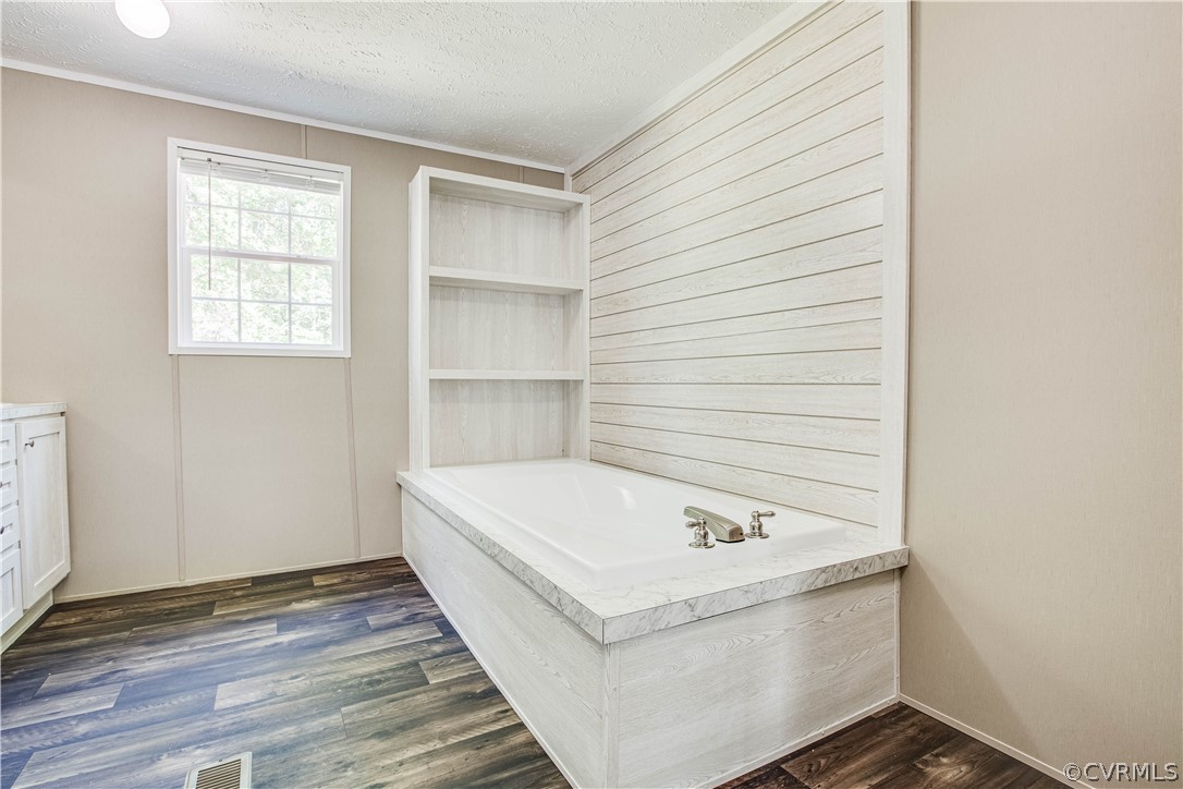 411 Goodwin Store Road Louisa, VA 23093 - Photo 6 of 38 a bathroom with a bathtub and a window