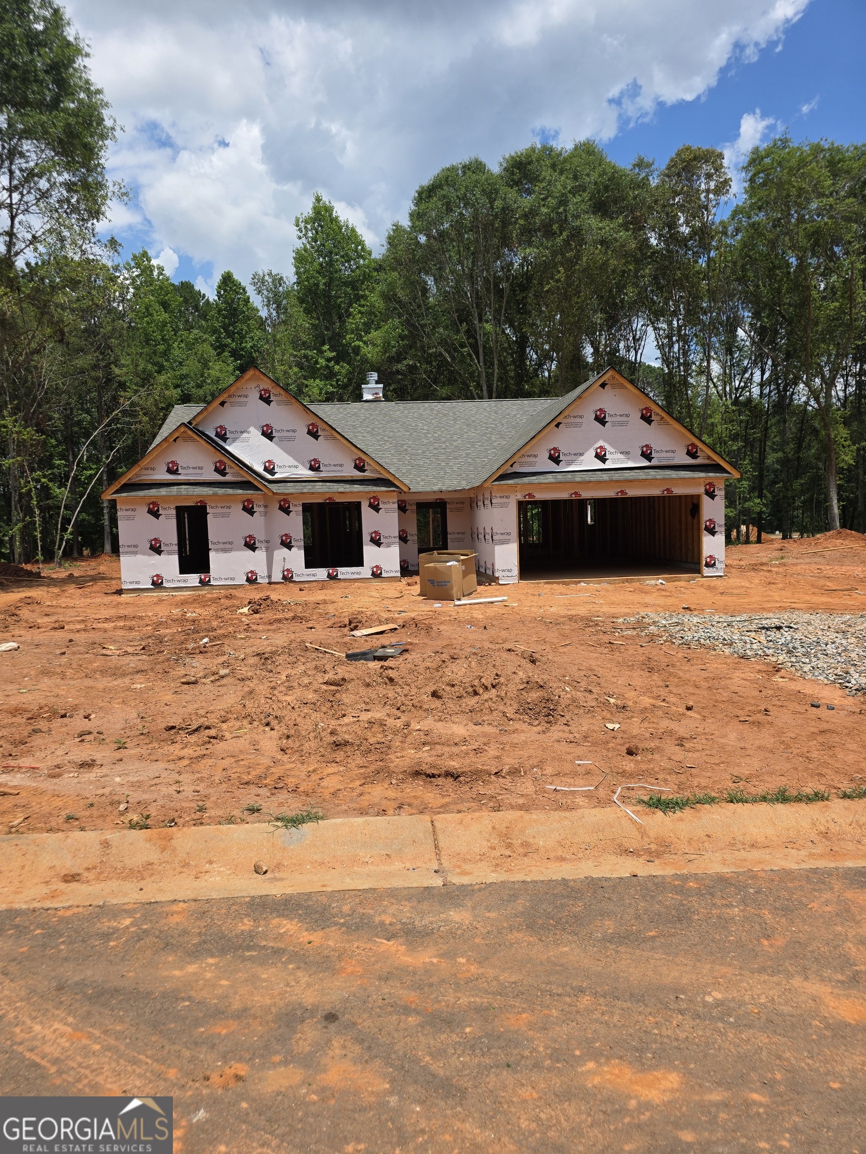 274 Mockingbird Lane, Unit 27 Winder, GA 30680 - Photo 1 of 29 a front view of a house with a yard and trees