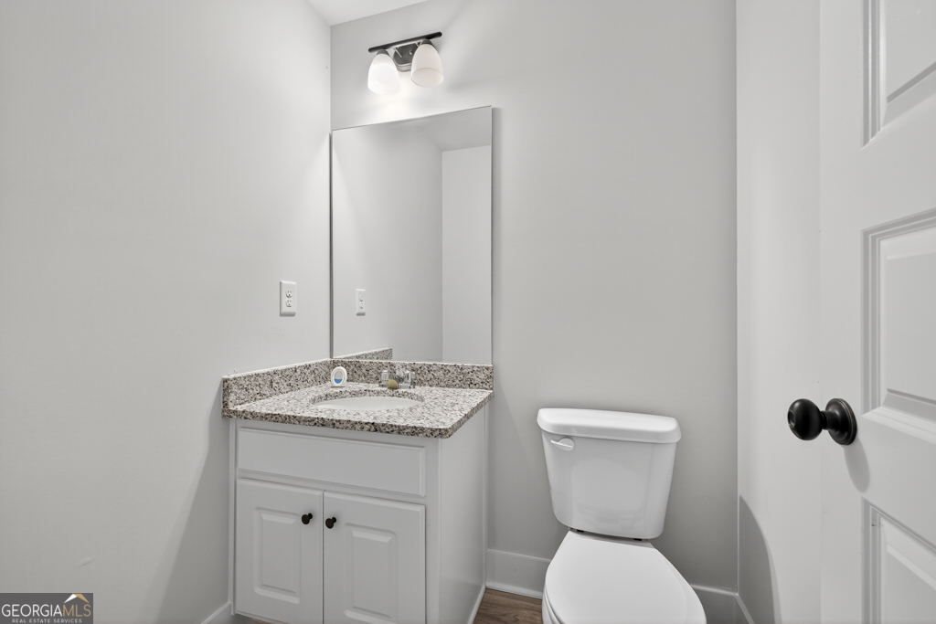 274 Mockingbird Lane, Unit 27 Winder, GA 30680 - Photo 13 of 29 a bathroom with a toilet sink and mirror