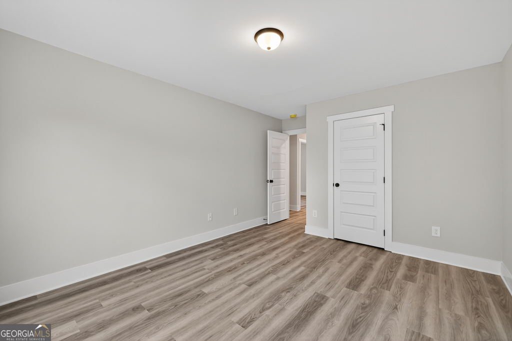 274 Mockingbird Lane, Unit 27 Winder, GA 30680 - Photo 15 of 29 wooden floor in an empty room