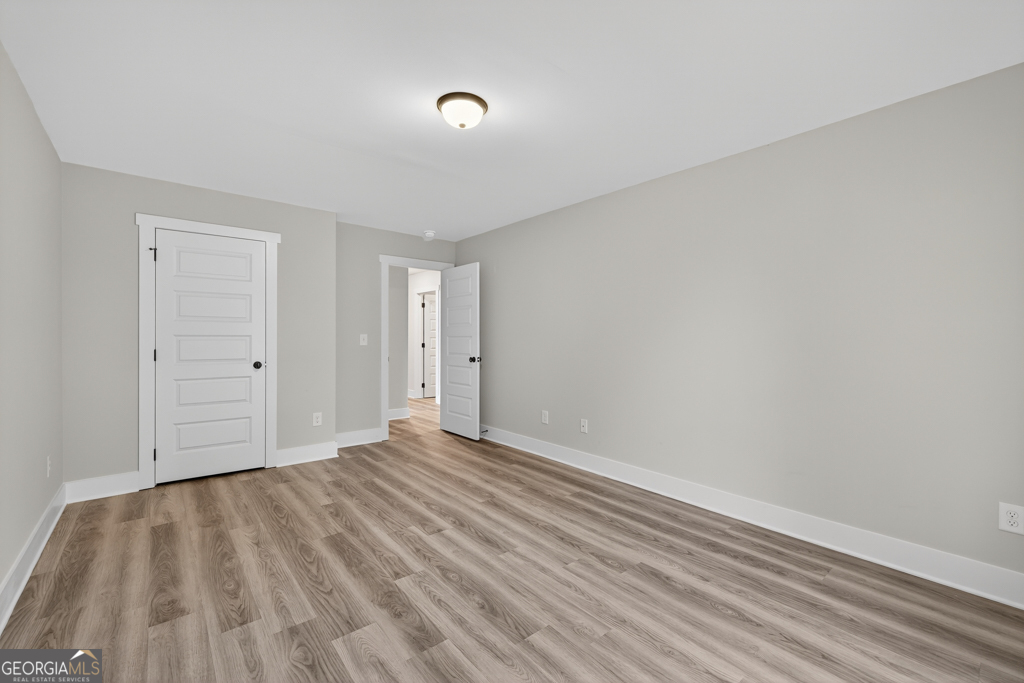 274 Mockingbird Lane, Unit 27 Winder, GA 30680 - Photo 17 of 29 a view of an empty room with wooden floor