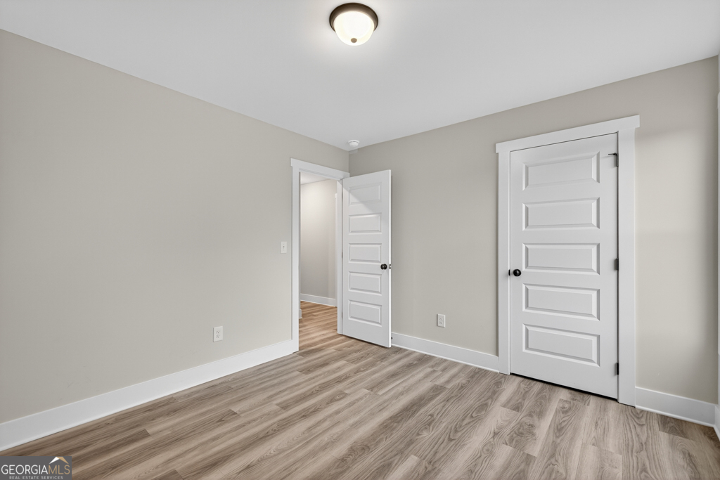 274 Mockingbird Lane, Unit 27 Winder, GA 30680 - Photo 19 of 29 a view of empty room with wooden floor
