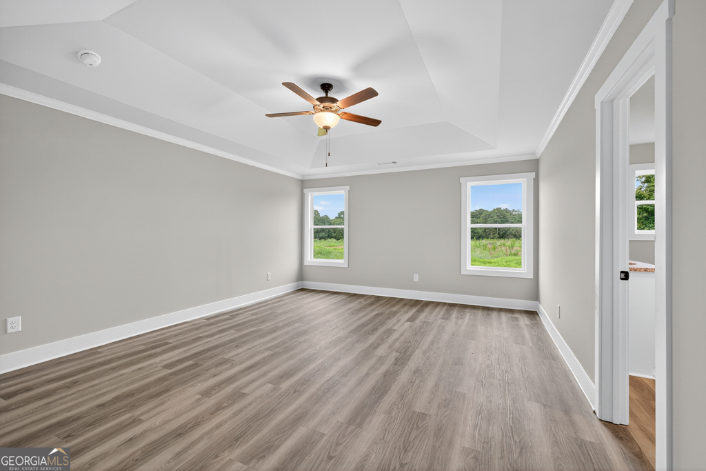 274 Mockingbird Lane, Unit 27 Winder, GA 30680 - Photo 20 of 29 wooden floor in an empty room with a window