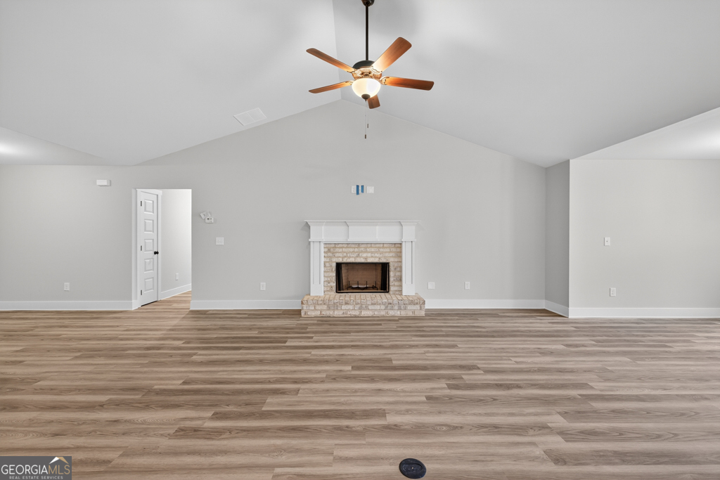 274 Mockingbird Lane, Unit 27 Winder, GA 30680 - Photo 6 of 29 a view of an empty room with a ceiling fan and a fireplace