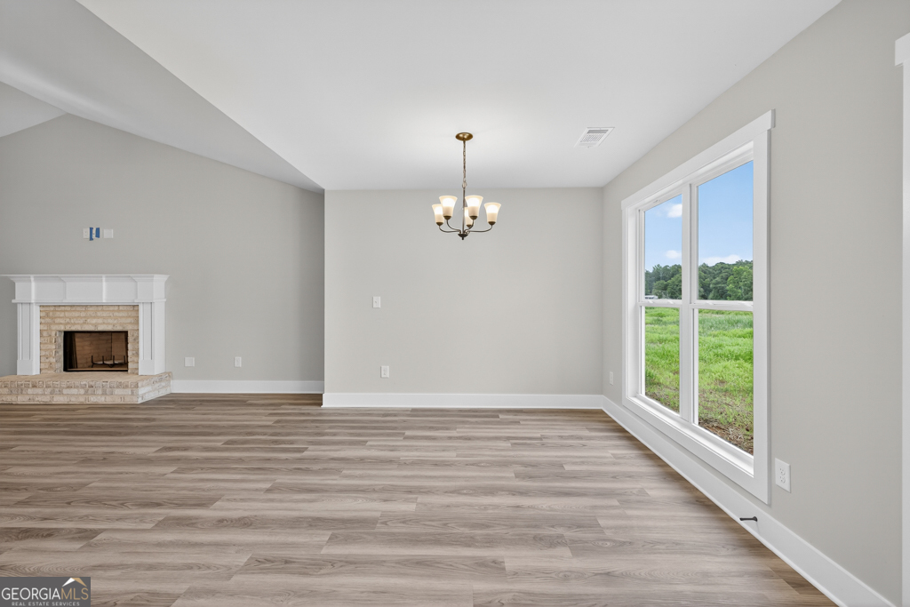 274 Mockingbird Lane, Unit 27 Winder, GA 30680 - Photo 10 of 29 a view of an empty room with window and wooden floor