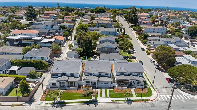 a living room with furniture a flat screen tv and kitchen view