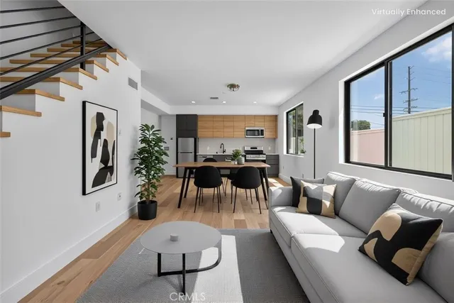 an aerial view of multiple houses with a swimming pool and outdoor seating