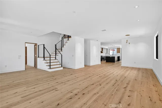 a large kitchen with stainless steel appliances granite countertop a sink and a stove