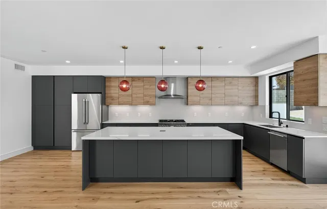 a kitchen with a sink a window and stainless steel appliances