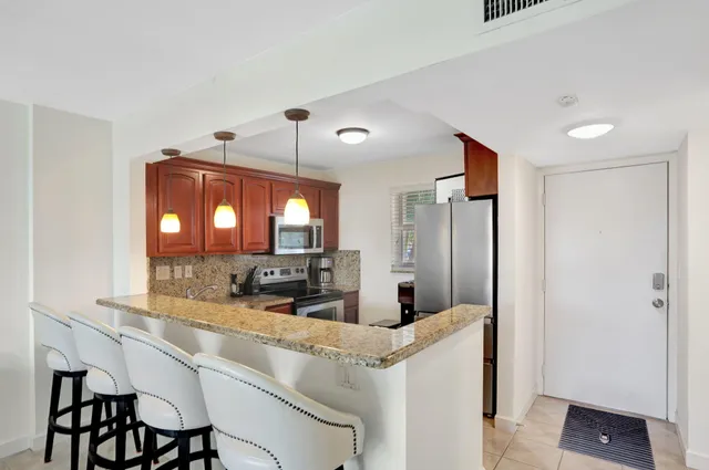 a kitchen with a refrigerator and microwave