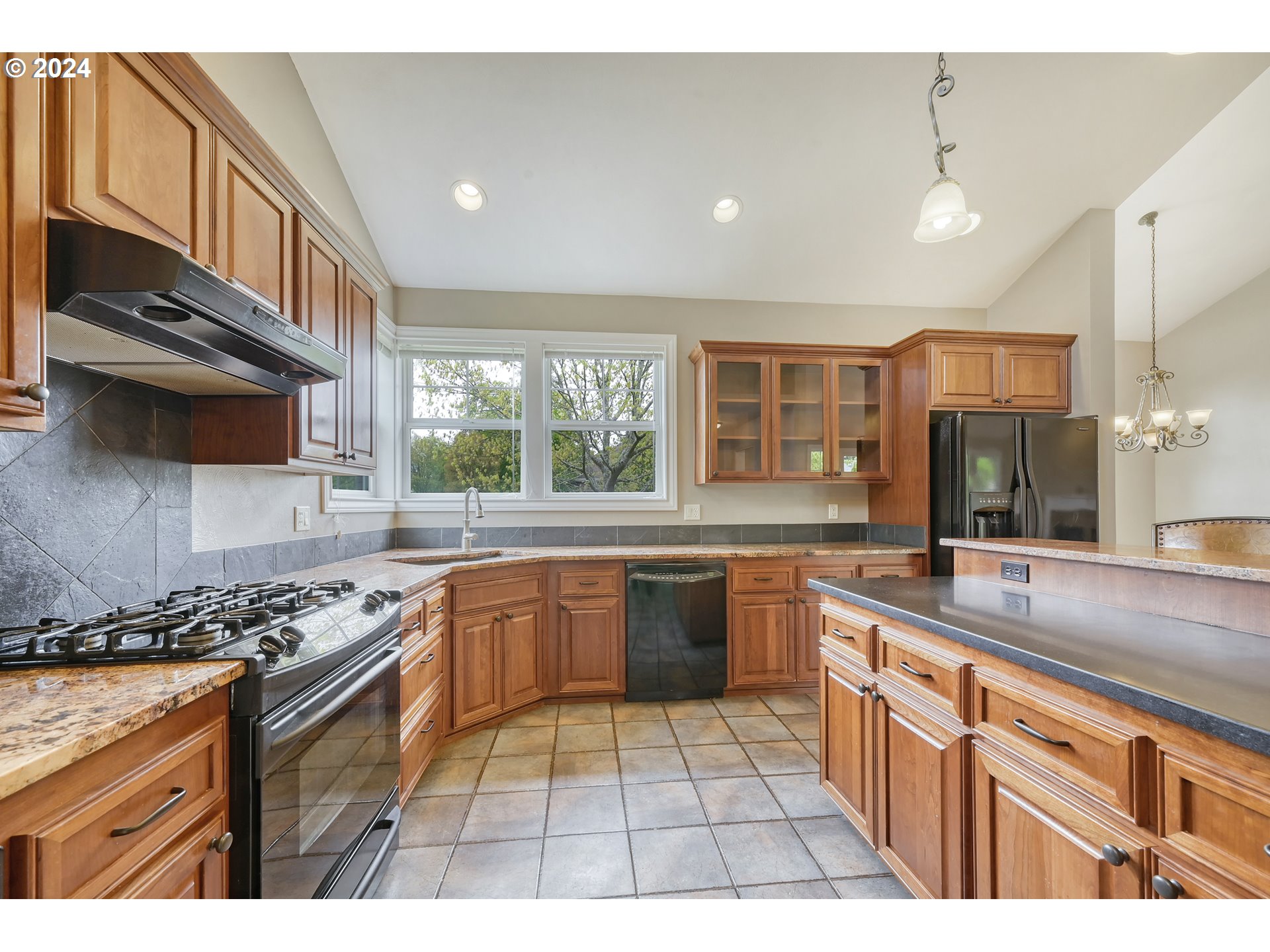 3349 Roanoke Avenue Eugene, OR 97408 - Photo 12 of 36 a kitchen with stainless steel appliances granite countertop a sink and stove