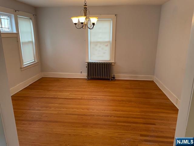 64 Beech Street Rutherford, NJ 07070 - Photo 4 of 17 an empty room with chandelier fan and windows