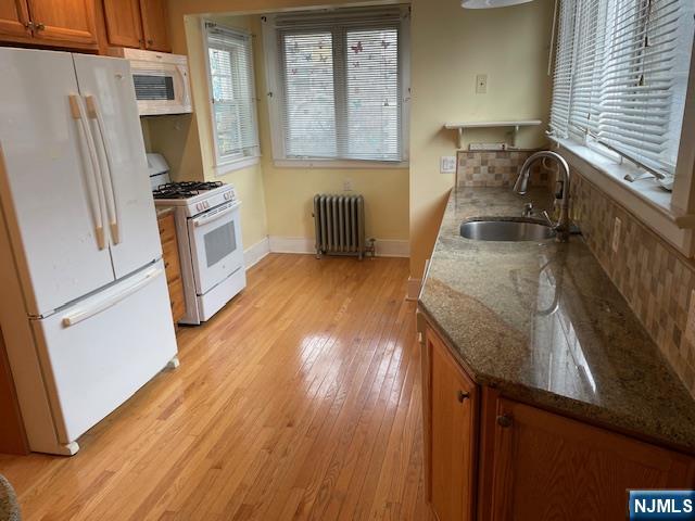 64 Beech Street Rutherford, NJ 07070 - Photo 5 of 17 a kitchen with granite countertop a sink stove and refrigerator