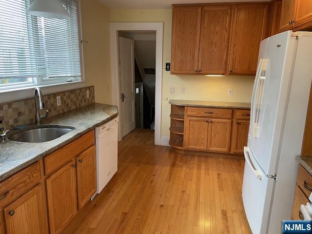 64 Beech Street Rutherford, NJ 07070 - Photo 6 of 17 a kitchen with stainless steel appliances granite countertop a sink dishwasher a refrigerator and a stove with wooden floors