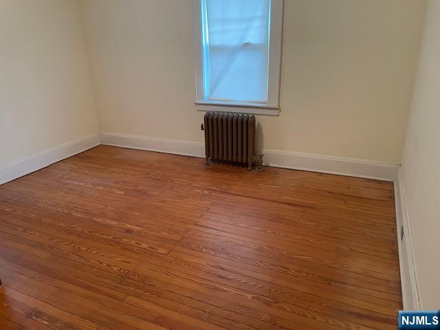 64 Beech Street Rutherford, NJ 07070 - Photo 7 of 17 a view of an empty room with wooden floor and a window