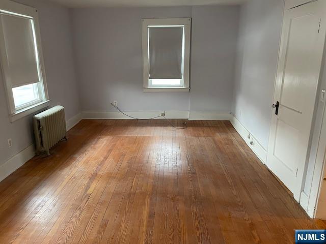 64 Beech Street Rutherford, NJ 07070 - Photo 8 of 17 an empty room with wooden floor and windows