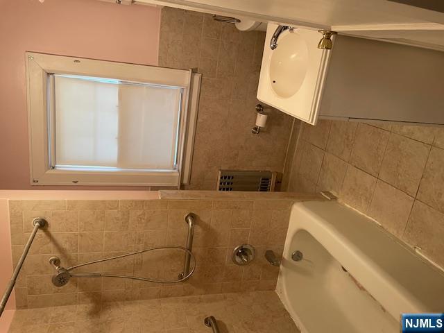 64 Beech Street Rutherford, NJ 07070 - Photo 10 of 17 a bathroom with a bath tub and a window