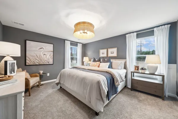 a bedroom with a bed and a large window