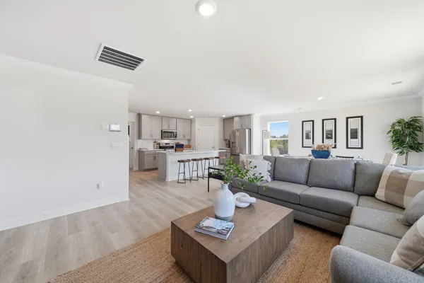 a living room with furniture kitchen and kitchen view
