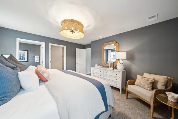 a bedroom with a bed and a chandelier