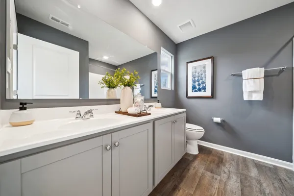 a bathroom with a toilet sink and mirror