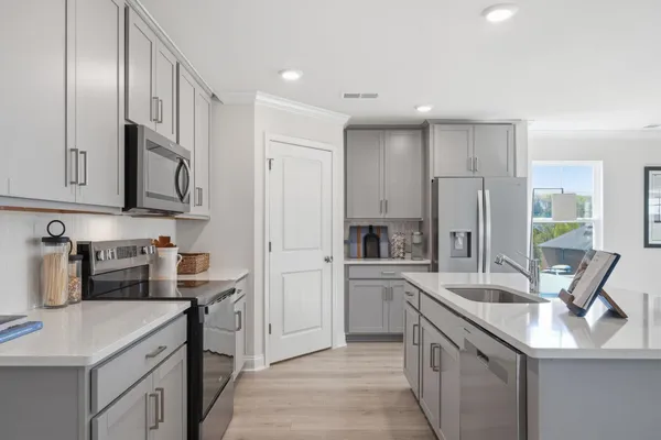 a kitchen with stainless steel appliances a refrigerator and a stove top oven