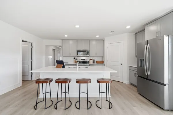 a living room with furniture and view of kitchen