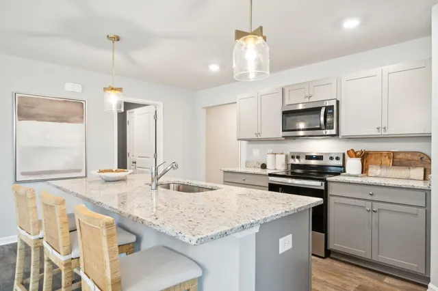 a kitchen with granite countertop kitchen island cabinets and a sink