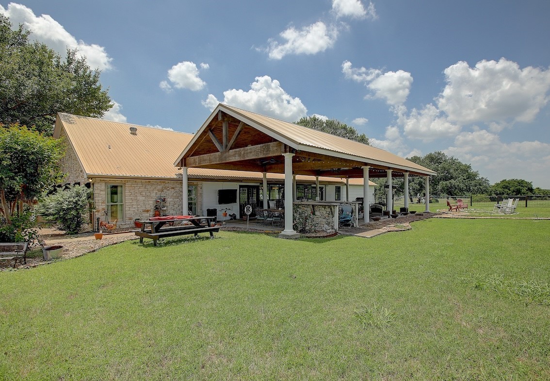 4214 Old College Road La Grange, TX 78945 - Photo 25 of 42 a view of a house with patio and a garden