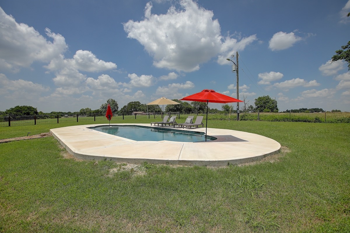 4214 Old College Road La Grange, TX 78945 - Photo 28 of 42 a view of a swimming pool with a yard