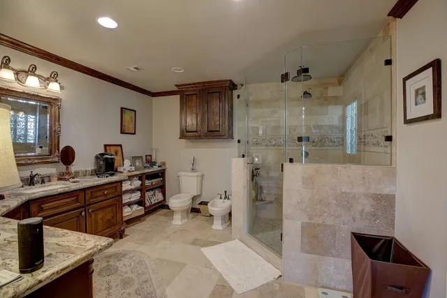 a spacious bathroom with double vanity and a shower
