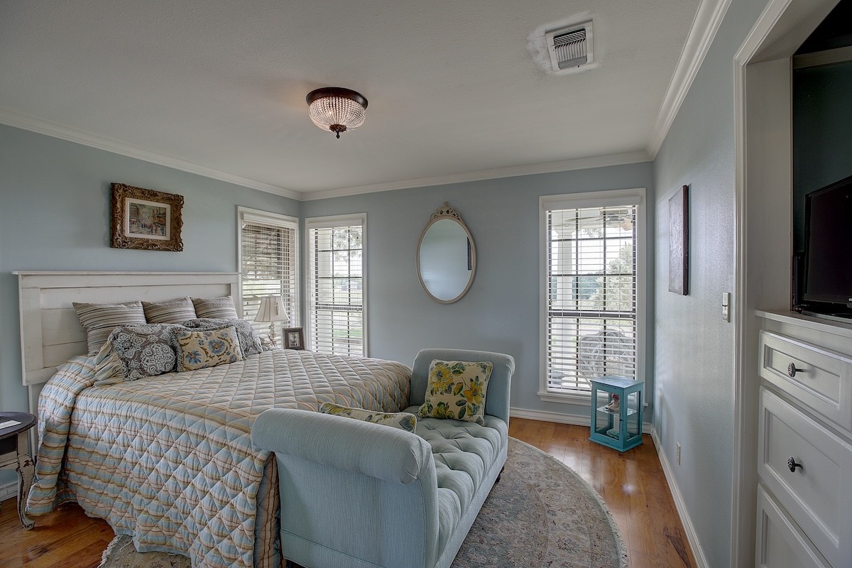 4214 Old College Road La Grange, TX 78945 - Photo 35 of 42 a bedroom with a bed and a flat tv screen on the dresser