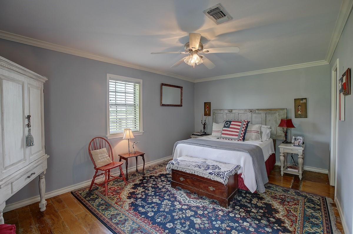 4214 Old College Road La Grange, TX 78945 - Photo 38 of 42 a bedroom with a bed chair and a window