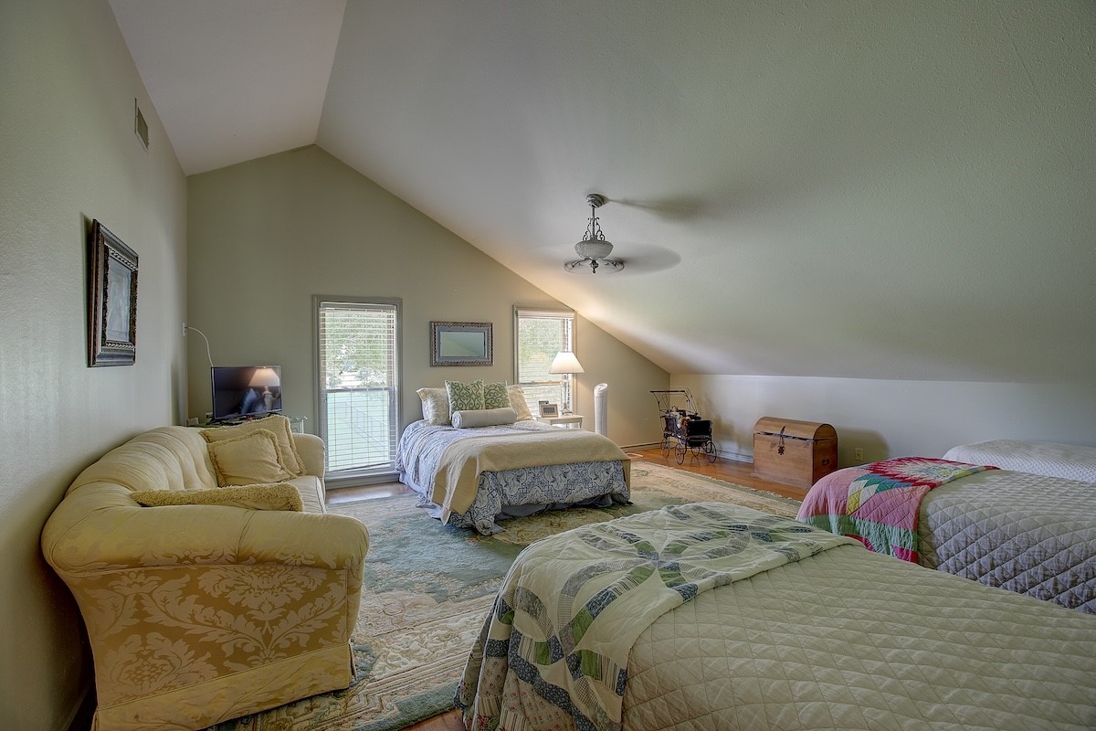 4214 Old College Road La Grange, TX 78945 - Photo 42 of 42 a spacious bedroom with a bed and couch