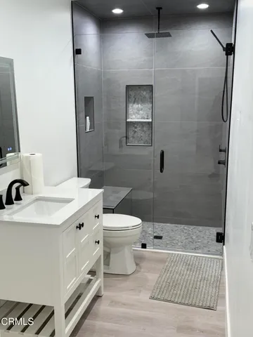 a bathroom with a sink a toilet and shower