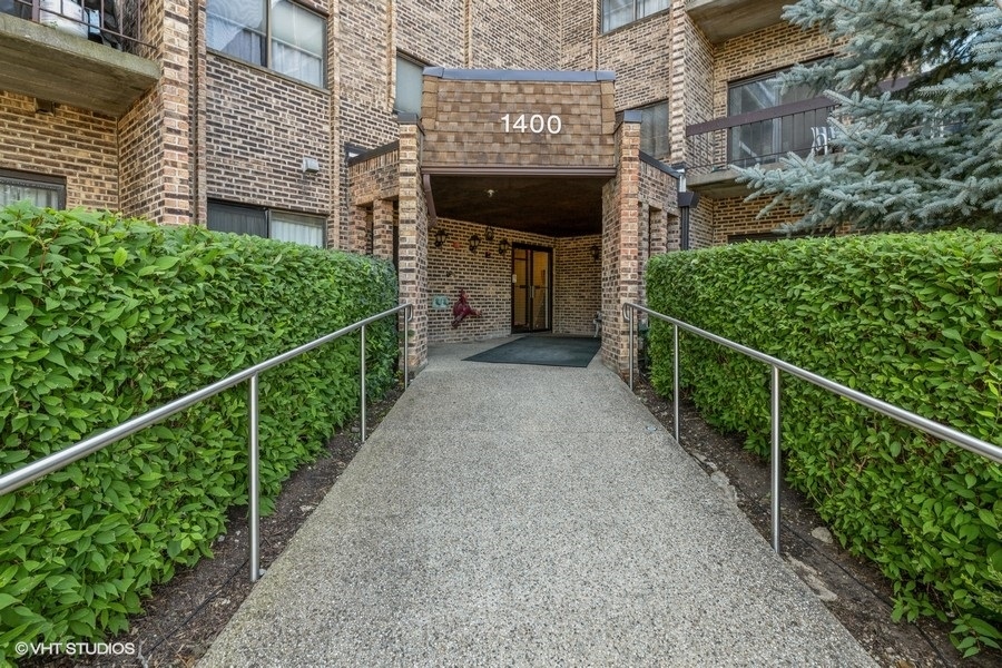 1400 North Elmhurst Road, Unit 411 Mount Prospect, IL 60056 - Photo 2 of 13 a view of a pathway of a house with a street