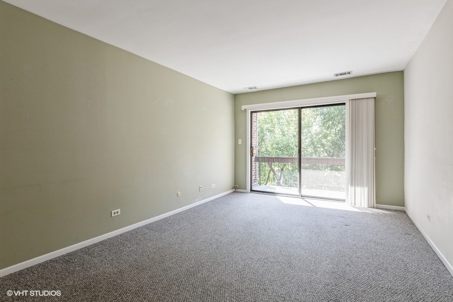 1400 North Elmhurst Road, Unit 411 Mount Prospect, IL 60056 - Photo 4 of 13 a view of an empty room with a window
