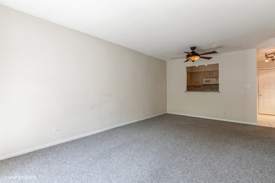 1400 North Elmhurst Road, Unit 411 Mount Prospect, IL 60056 - Photo 6 of 13 an empty room with a window
