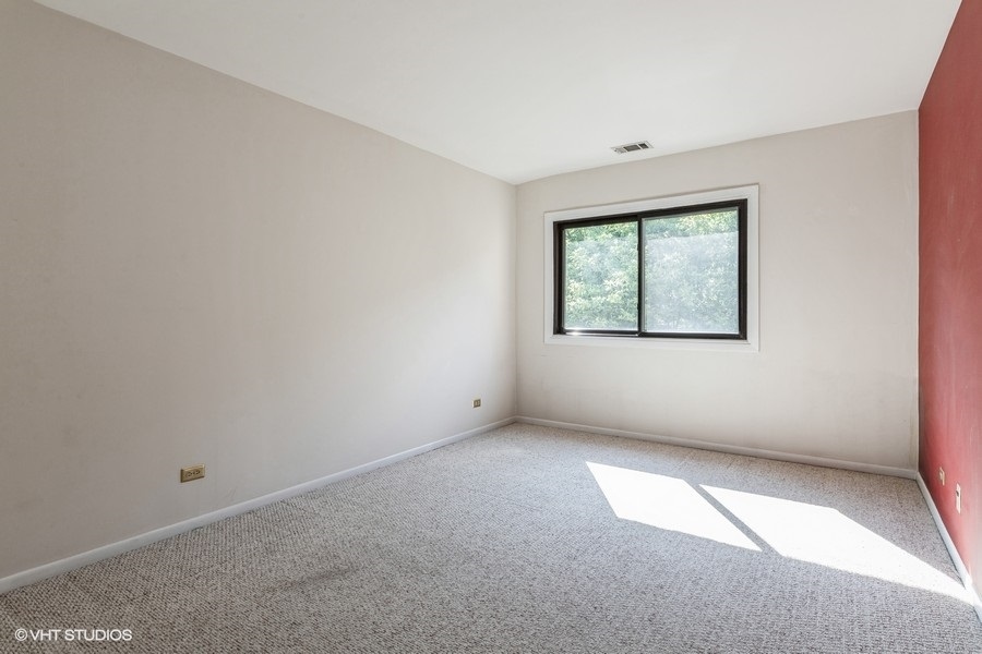 1400 North Elmhurst Road, Unit 411 Mount Prospect, IL 60056 - Photo 9 of 13 an empty room with a window